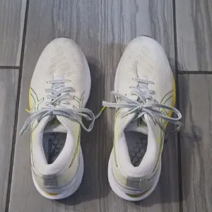 White and Yellow Athletic Shoes